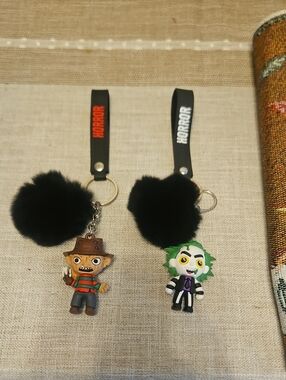Black Pom Pom Keychains with Freddy & Green-Haired Beetlejuice Charms
